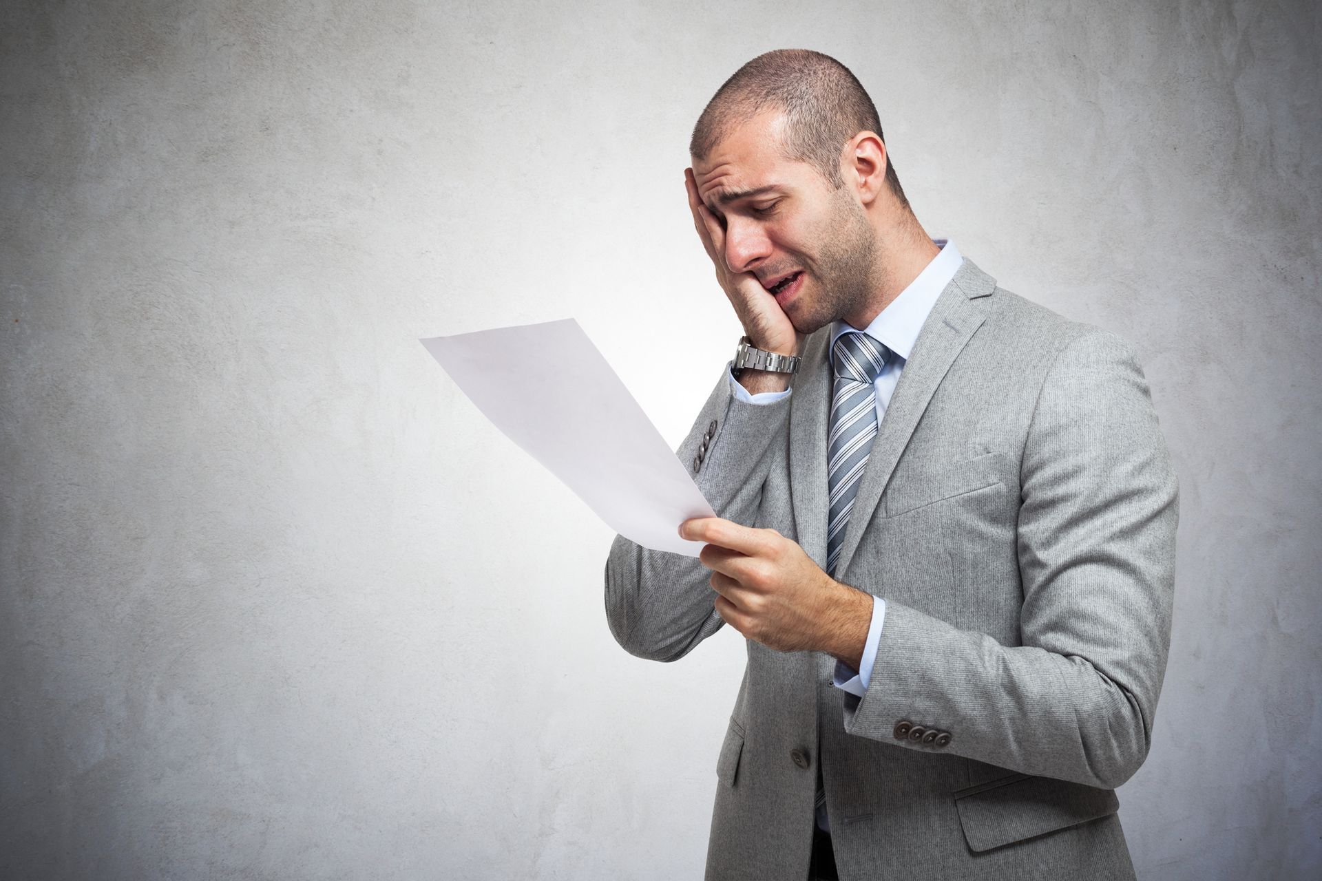 Worried man looking at a bill