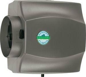 Wall-mounted gray automatic hand dryer with a green logo