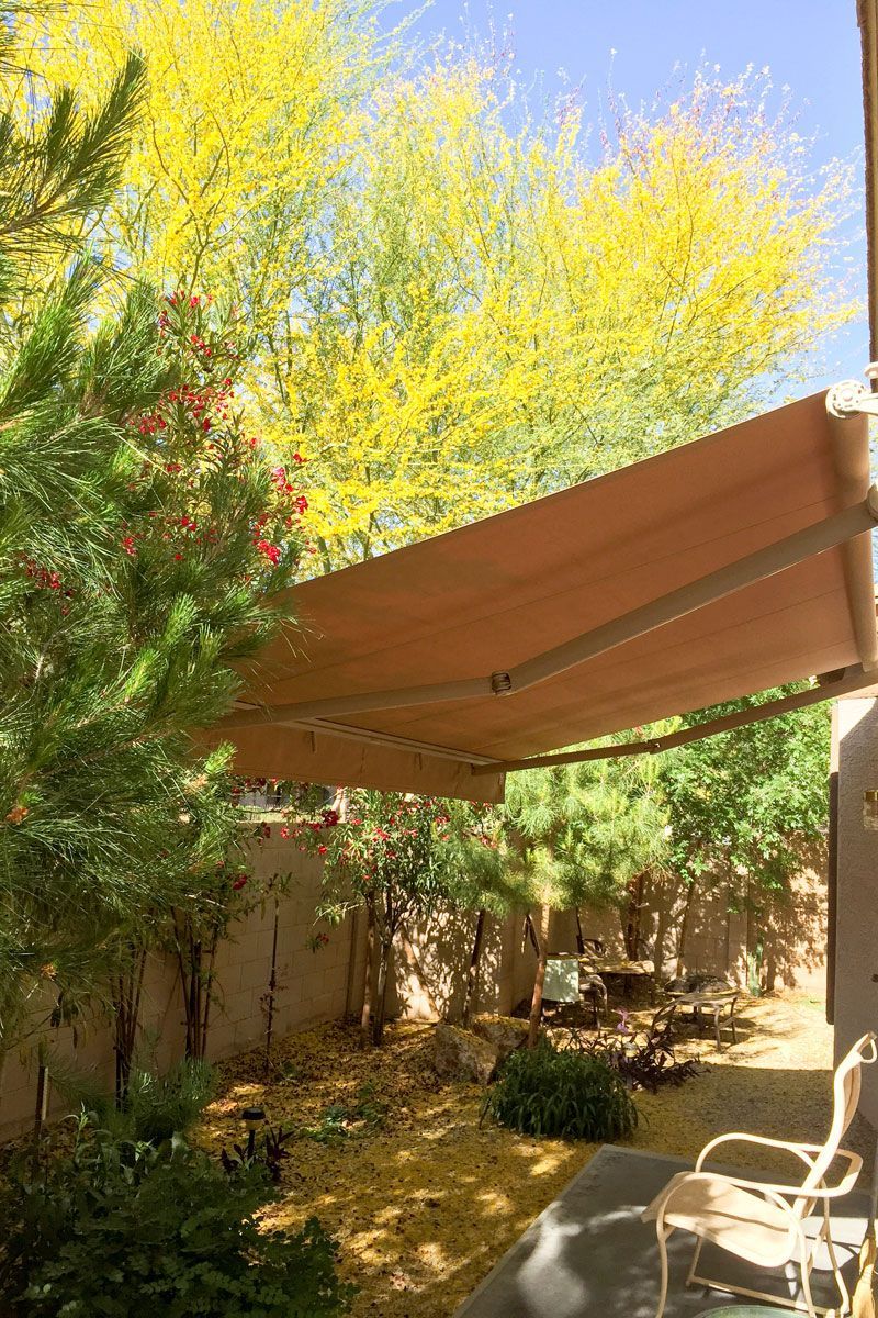 Outdoor kitchen with a grill, retractable awning that need maintenace