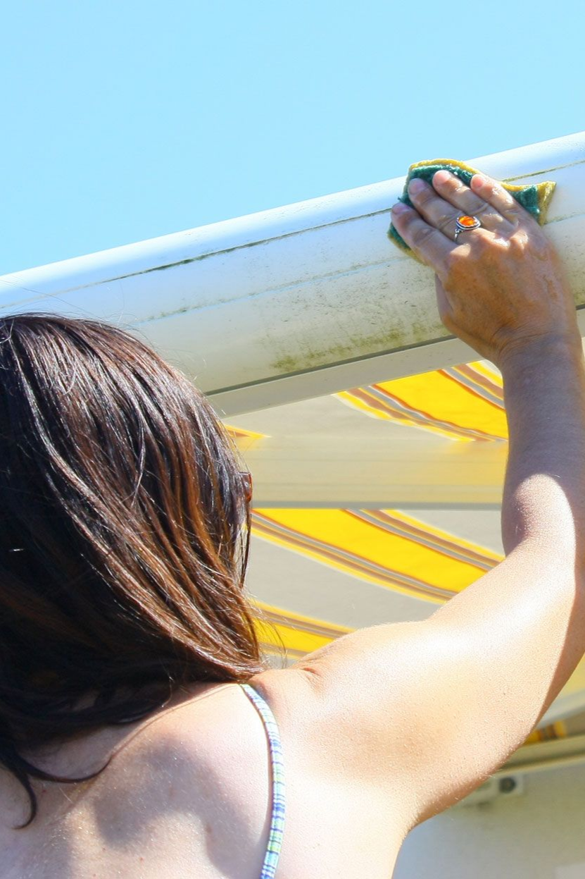 woman whipping down awning
