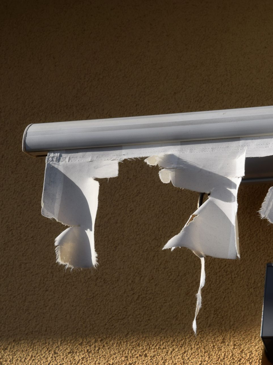 torn awning that needs repair