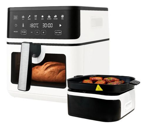 Horno freidora de aire en blanco y negro con pan en su interior y una bandeja extraíble con verduras asadas al lado.