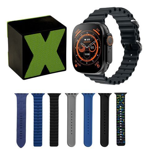 Apple Watch con correa negra junto a una caja; debajo se muestran siete correas intercambiables en azul, negro,