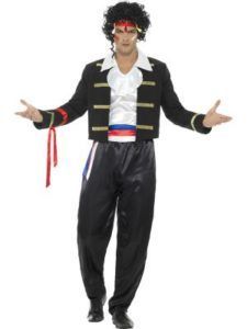 Man in a Costume With Black Jacket, Pants, and Curly Wig, Arms Outstretched — Costumes Galore in Maroochydore, QLD