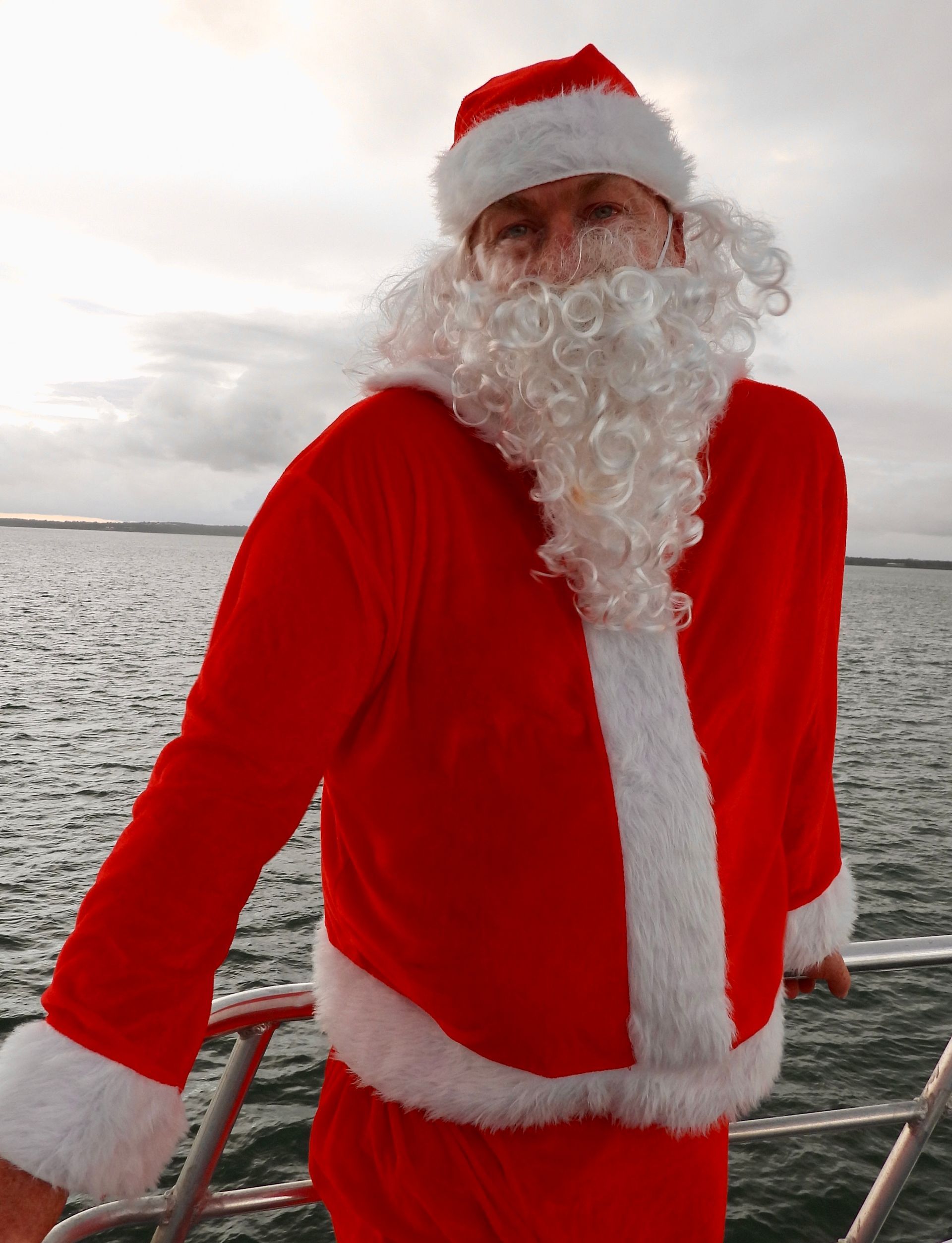 A Man In A Santa Claus Costume On A Boat — Costumes Galore in Maroochydore, QLD