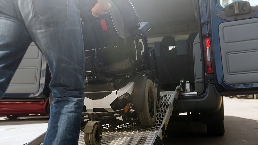 man pushing a wheelchair