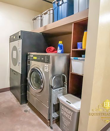 Laundry room with washer, dryer, shelves, and stacked bins in a tidy utility area