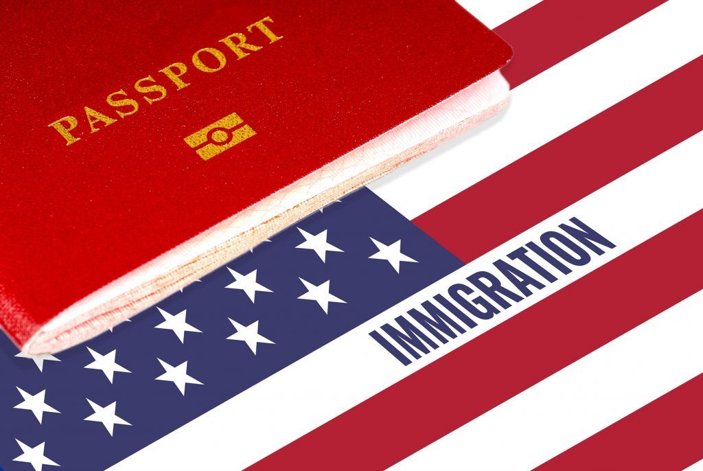 Red passport over U.S. flag with the word “IMMIGRATION” on it