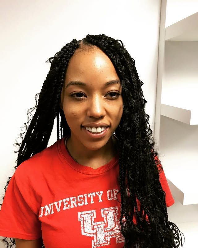 Smiling person in a red University of Houston T-shirt indoors