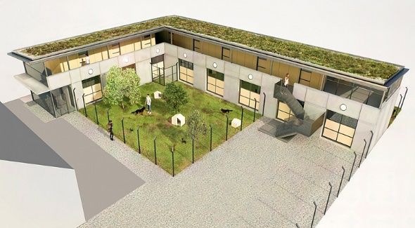 Luftaufnahme eines modernen Hofgebäudes mit umzäuntem Garten und umlaufenden Gehwegen