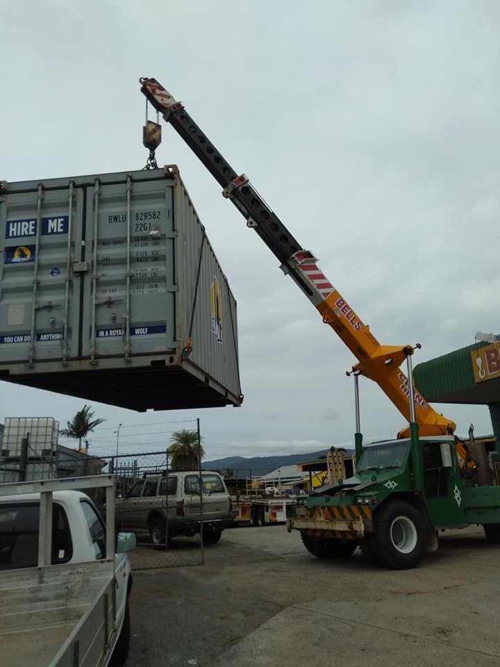 A Crane Lifts a Shipping Container — Bell's Carrying & Crane Hire Service Pty Ltd in Bungalow, QLD