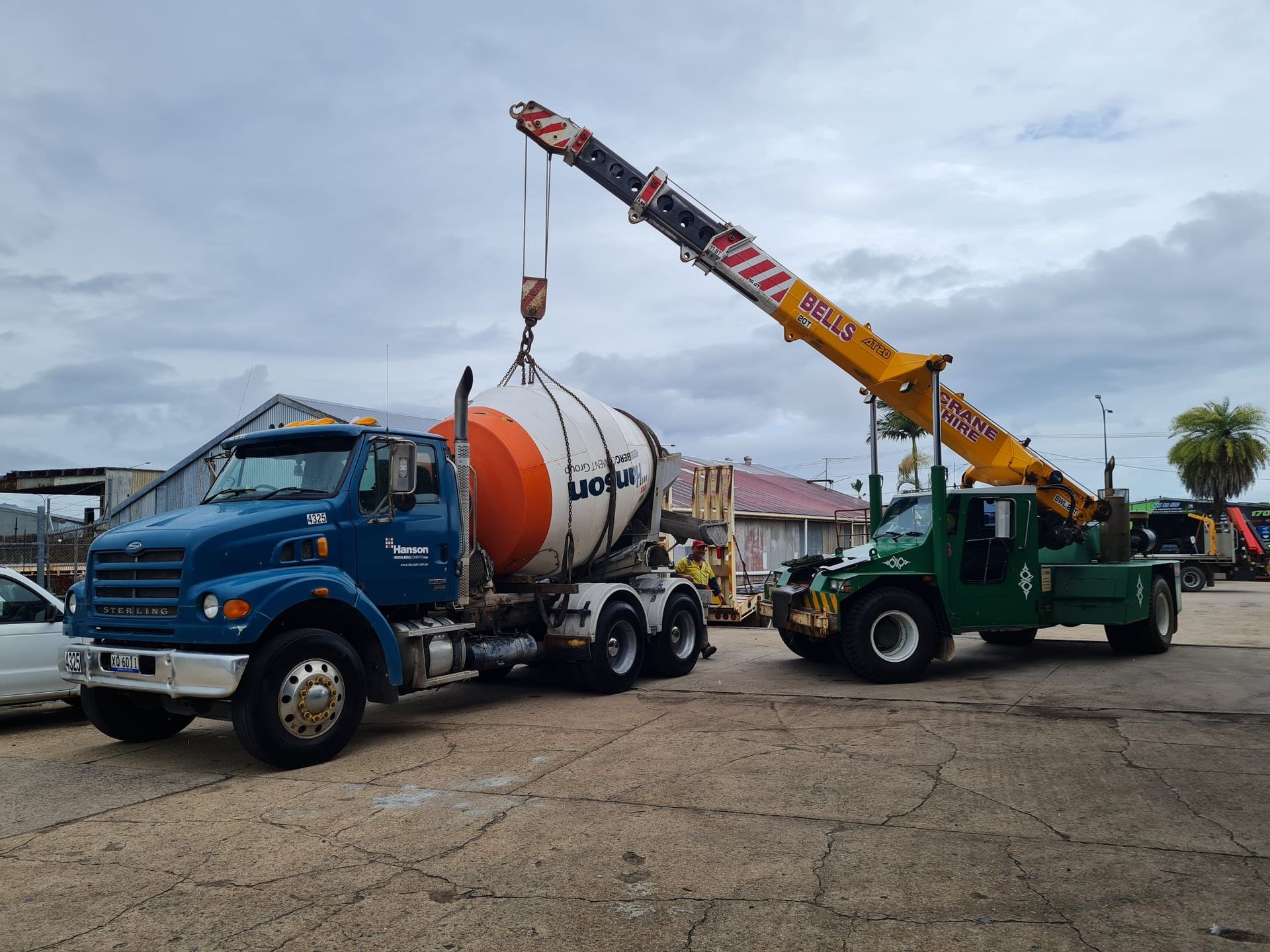 A Concrete Mixer Being Lifted by a Crane — Bell's Carrying & Crane Hire Service Pty Ltd in Chillagoe, QLD