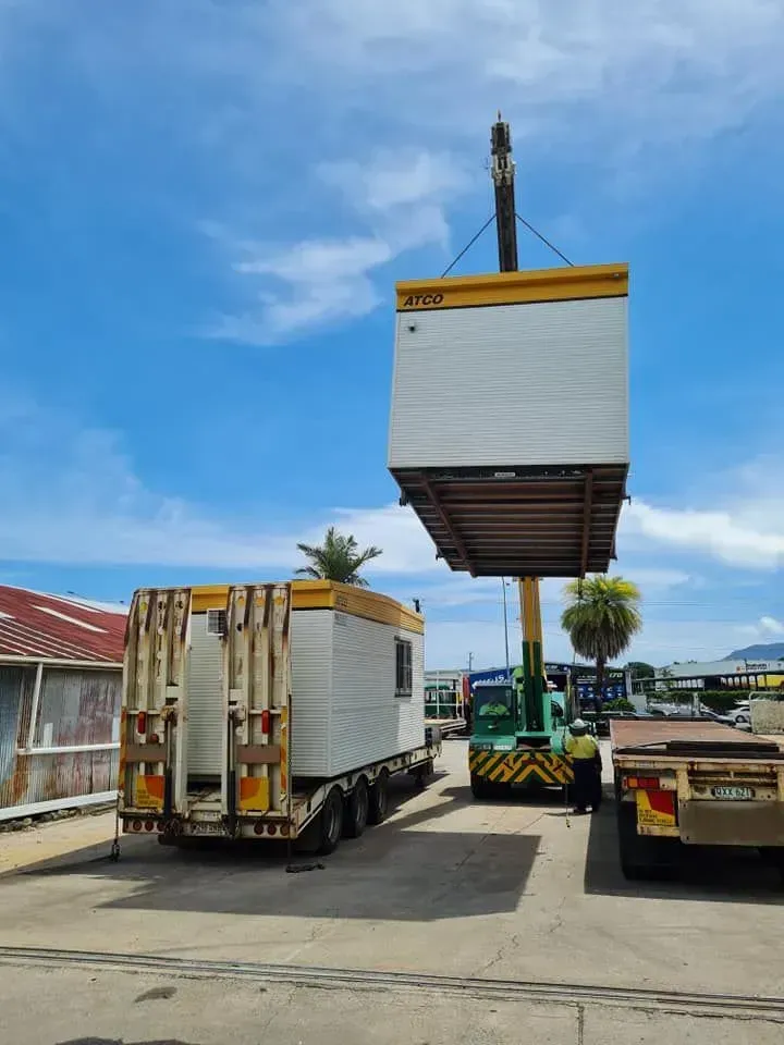 A Crane Lifting a White and Yellow — Bell's Carrying & Crane Hire Service Pty Ltd in Atherton, QLD