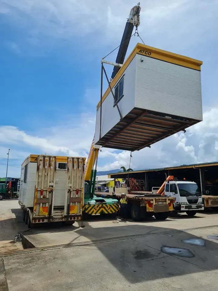 A Crane Lifting a White and Yellow — Bell's Carrying & Crane Hire Service Pty Ltd in Mareeba, QLD