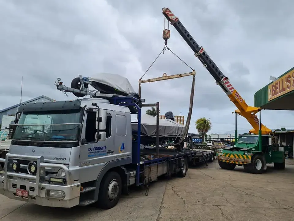 A Crane Lifting a Boat Off — Bell's Carrying & Crane Hire Service Pty Ltd in Atherton, QLD