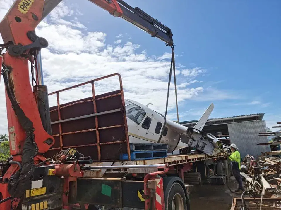 A Crane Lifting a White Airplane — Bell's Carrying & Crane Hire Service Pty Ltd in Normanton, QLD