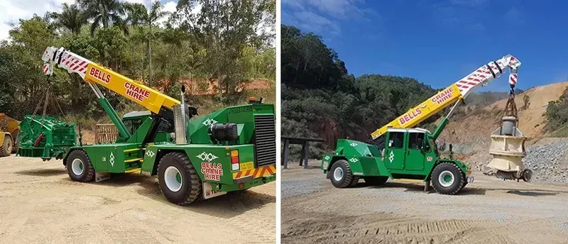 Green construction truck with raised orange crane arm — Bell's Carrying & Crane Hire Service Pty Ltd in Atherton, QLD