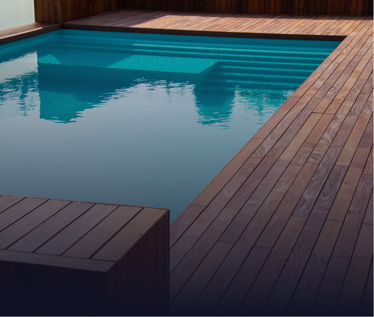 Swimming pool with wooden deck. Clear turquoise water, dark wood.