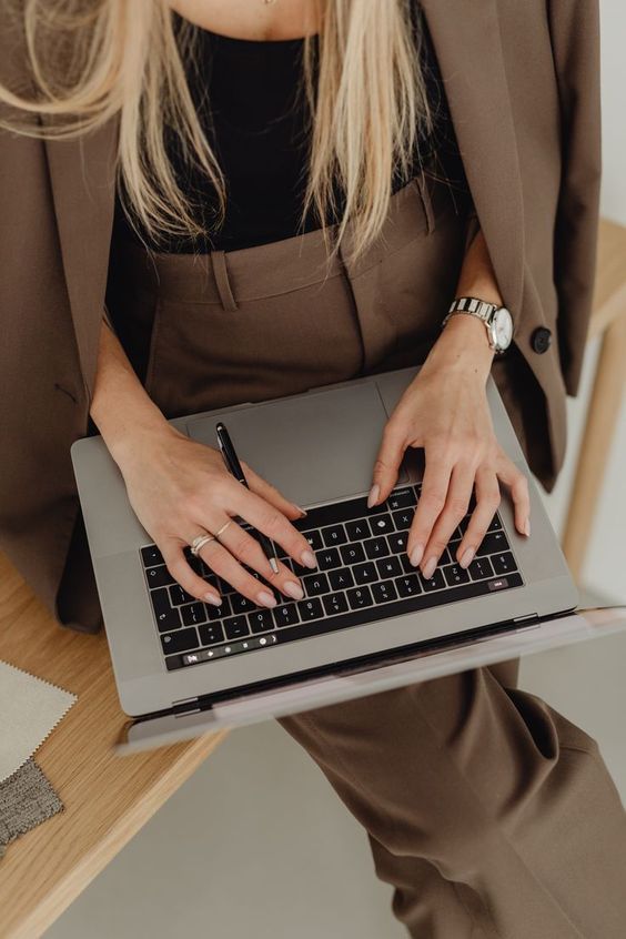 woman typing on laptop at a full-service marketing agency