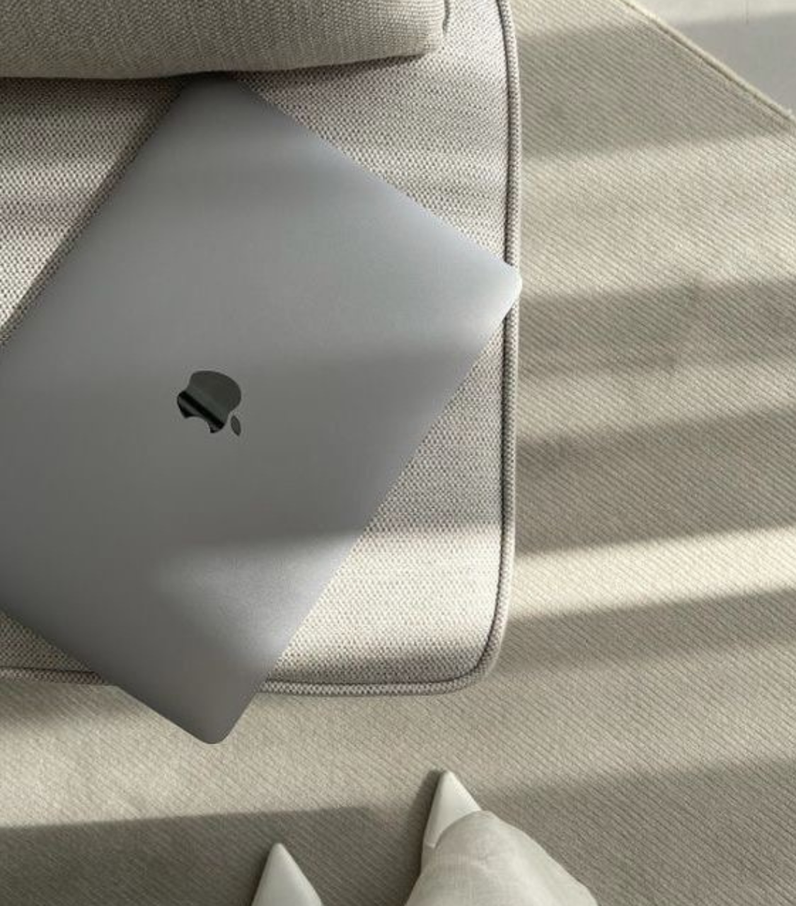A laptop computer is sitting on top of a couch.
