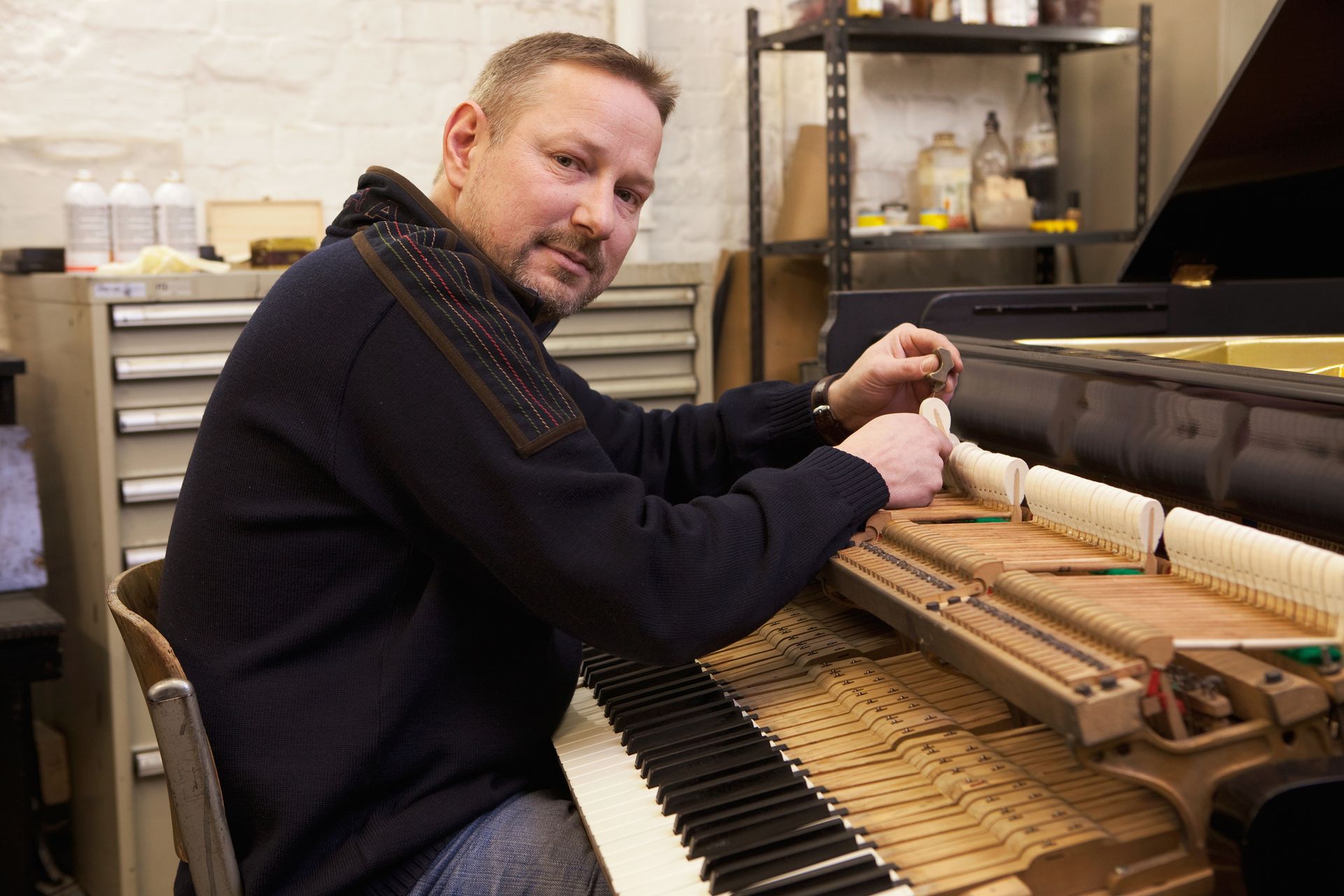 A woman is teaching a boy how to play the piano. A woman is teaching a boy how to play the piano.