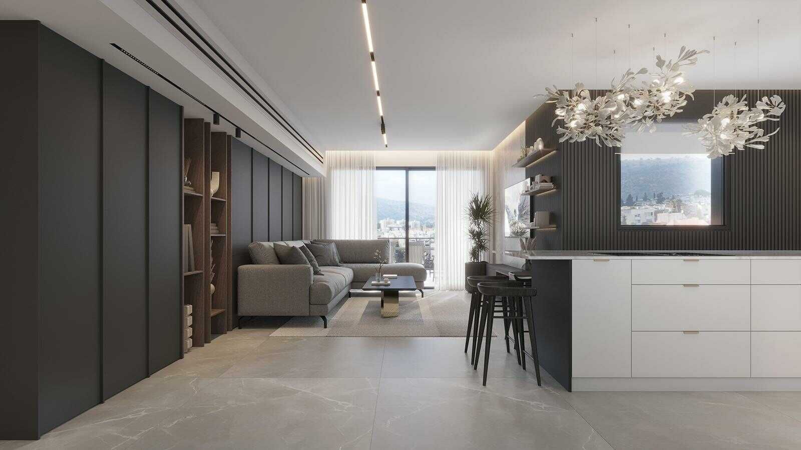 חלל ציבורי פתוח בדירת קבלן הכולל סלון מודרני עם קיר נגרות כהה לאחסון נסתר ועיצוב סינרגי המייצר זרימה הרמונית - מעצבת פנים שמרית אוחיון.