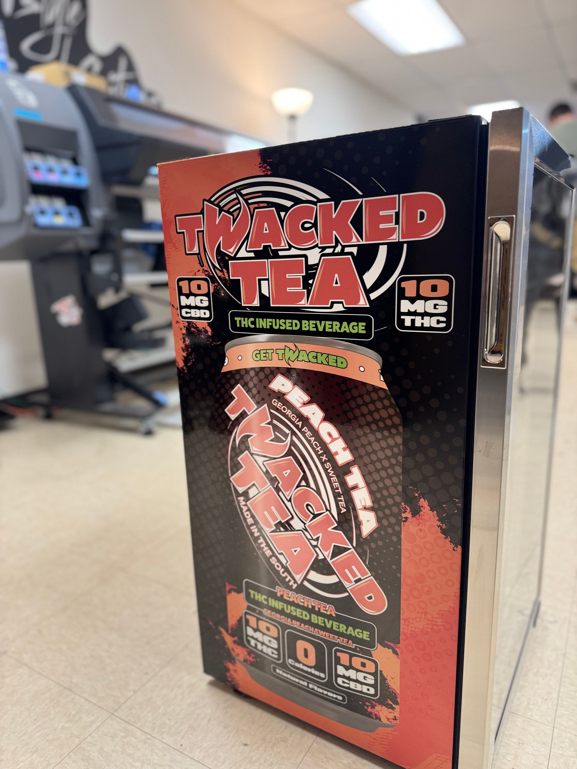 Twacked Tea box on a store shelf, black packaging with red lettering and a tea bottle graphic
