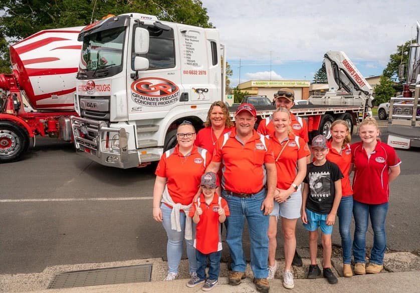 A Group of People Are Standing in Front of a Truck — Graham's Precast Concrete Products Pty Ltd in Kyogle, NSW
