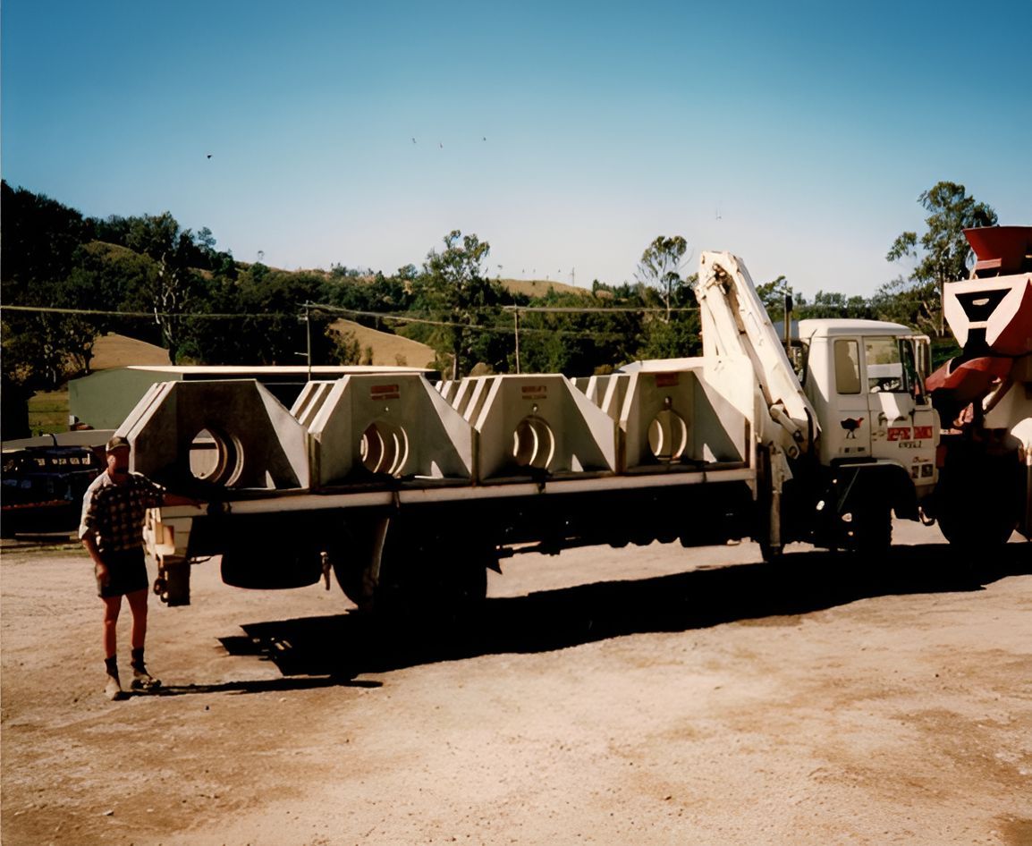 A Man Stands in Front of a Truck That Says Oyana — Graham's Precast Concrete Products Pty Ltd in Kyogle, NSW