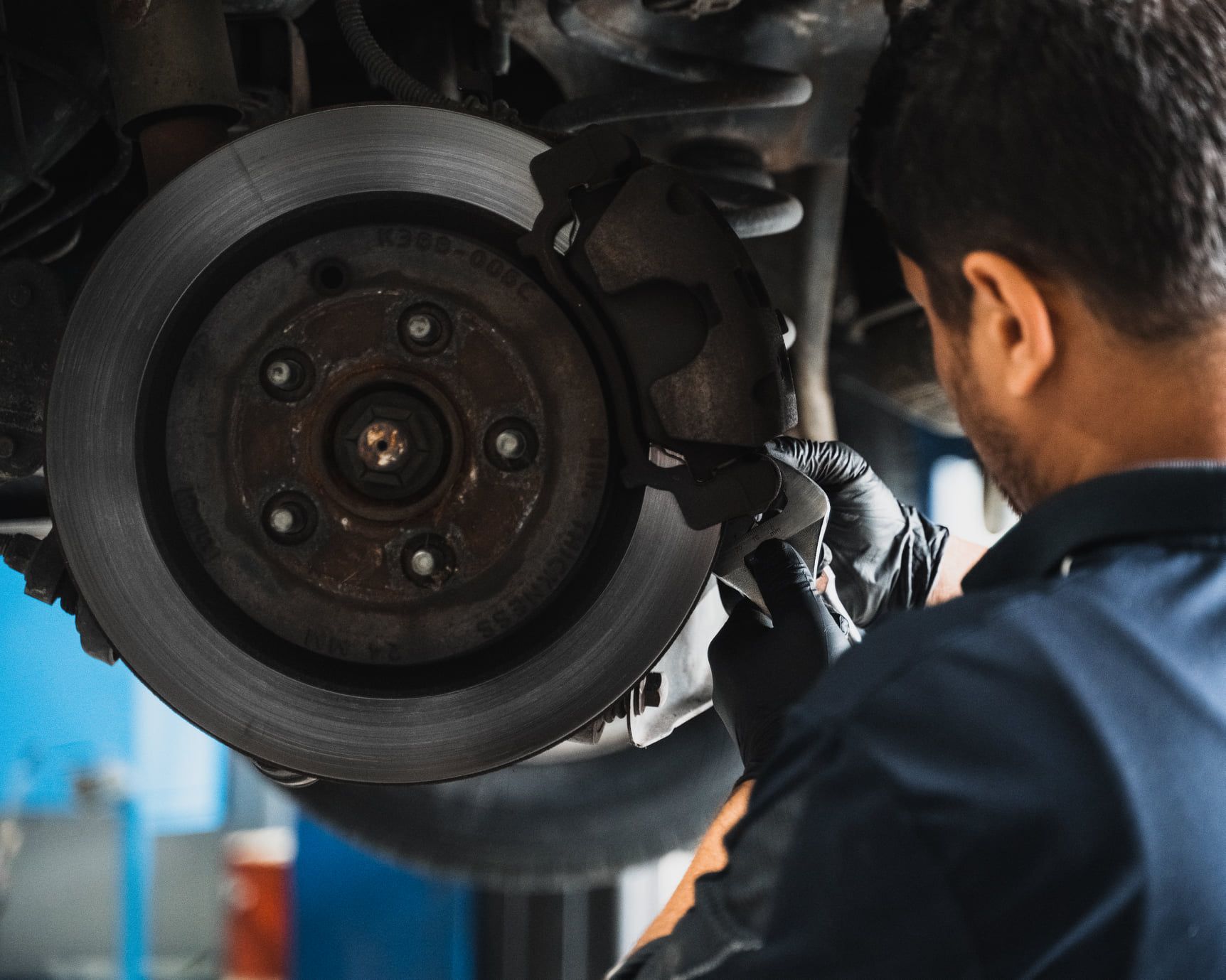 Mechanic Inspecting a Car’s Brake Assembly — Gardiner Automotive & Performance in Rutherford, NSW
