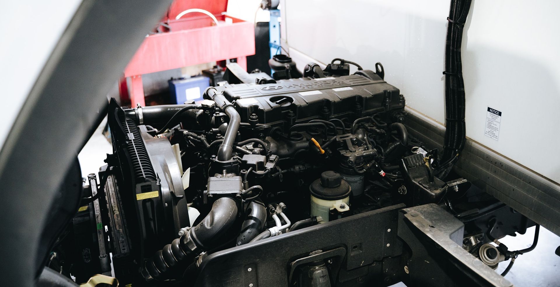 Open Engine Compartment with Exposed Black Machinery — Gardiner Automotive & Performance in Rutherford, NSW