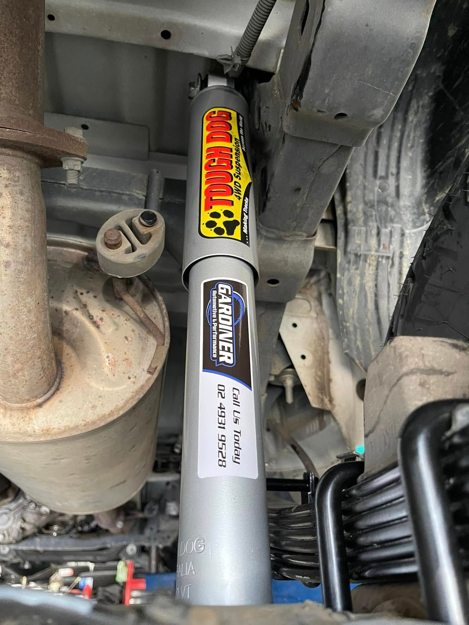 Vehicle Undercarriage with Grey Shock Absorber, Suspension Parts — Gardiner Automotive & Performance in Rutherford, NSW