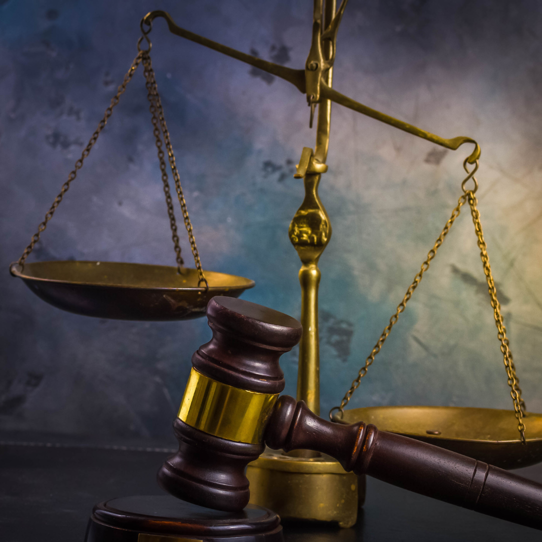 a judge 's gavel and scales of justice on a table . Crown Point, IN
