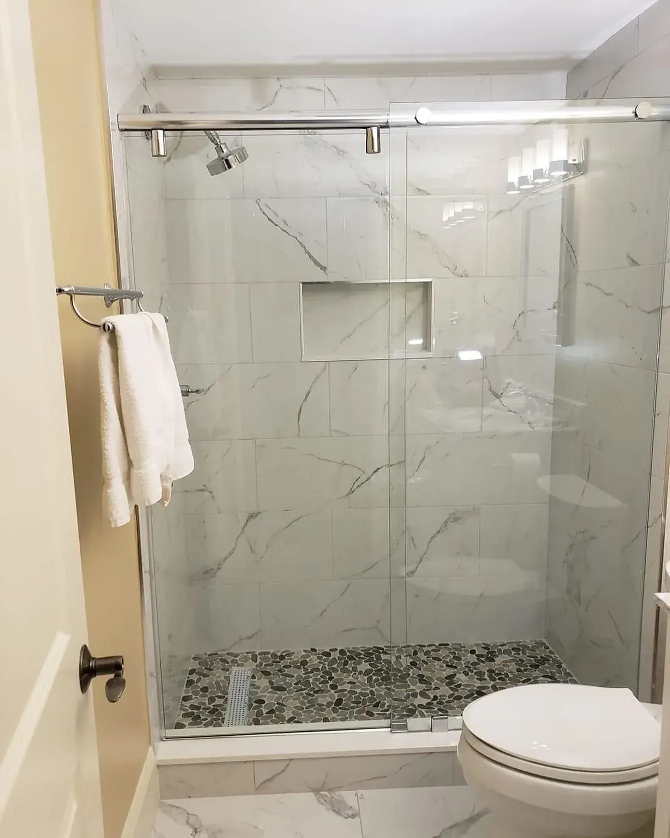 Frameless glass shower enclosure in a finished bathroom