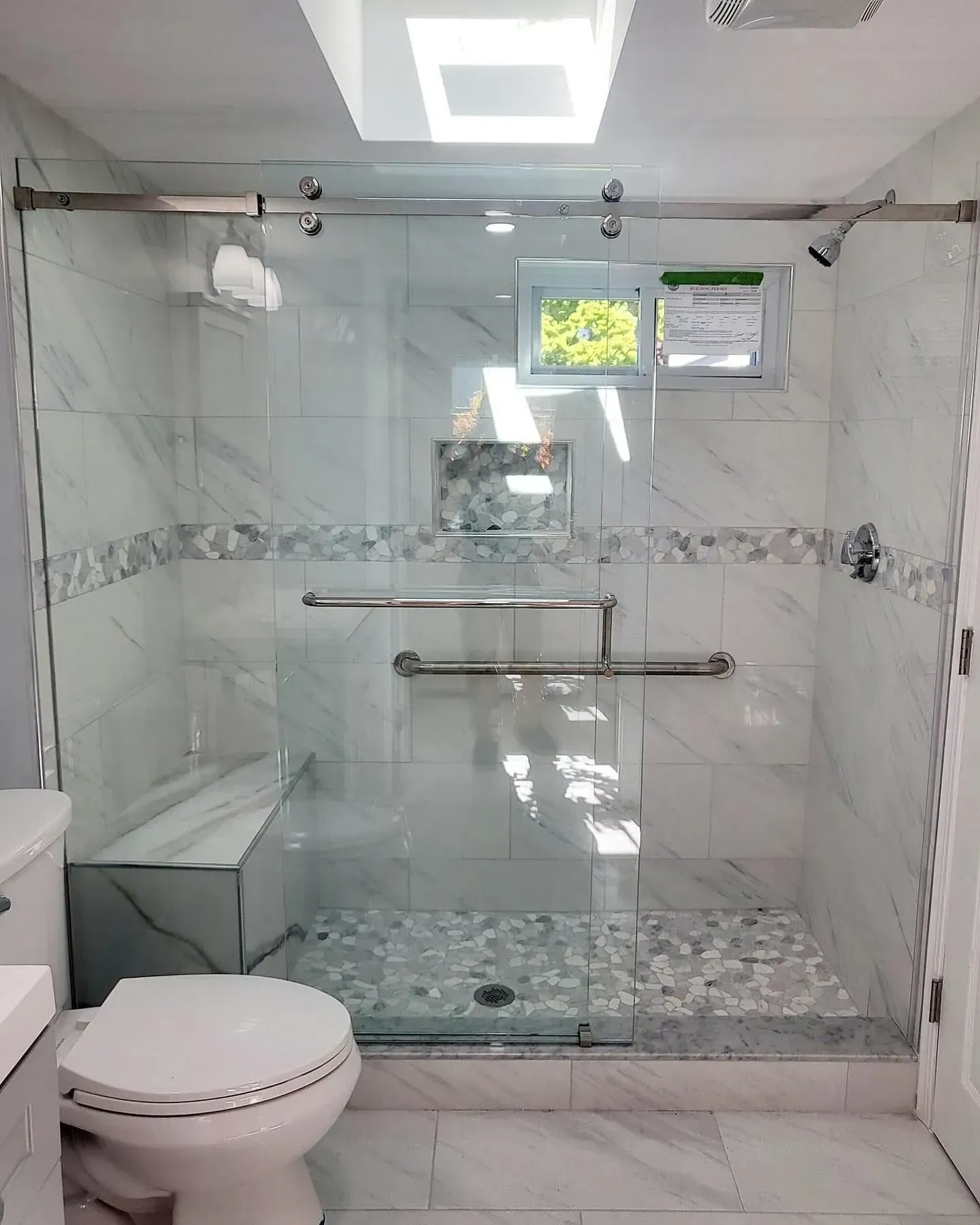 Finished glass shower door and enclosure in a tiled bathroom
