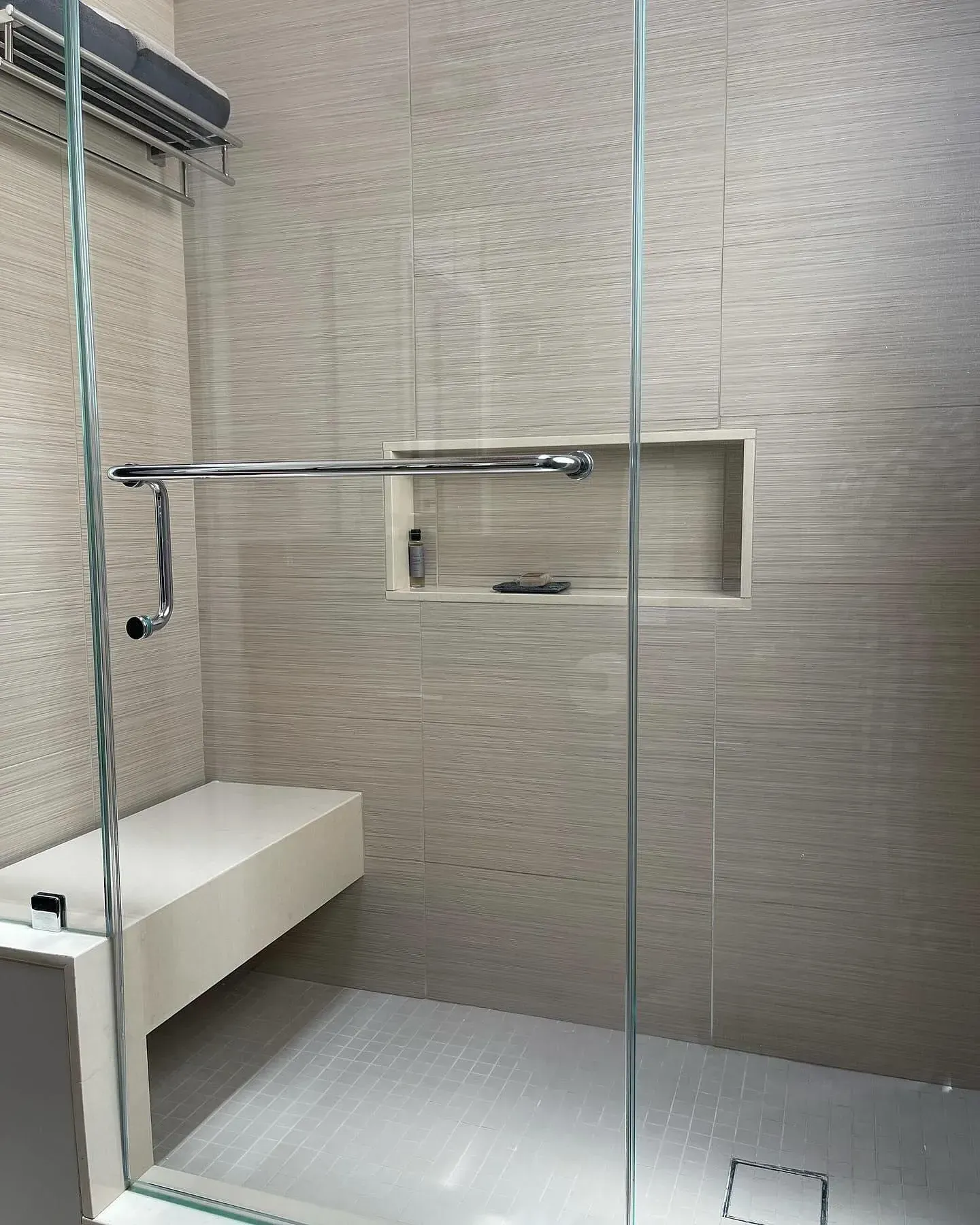 Frameless shower opening with glass hardware and finished tile