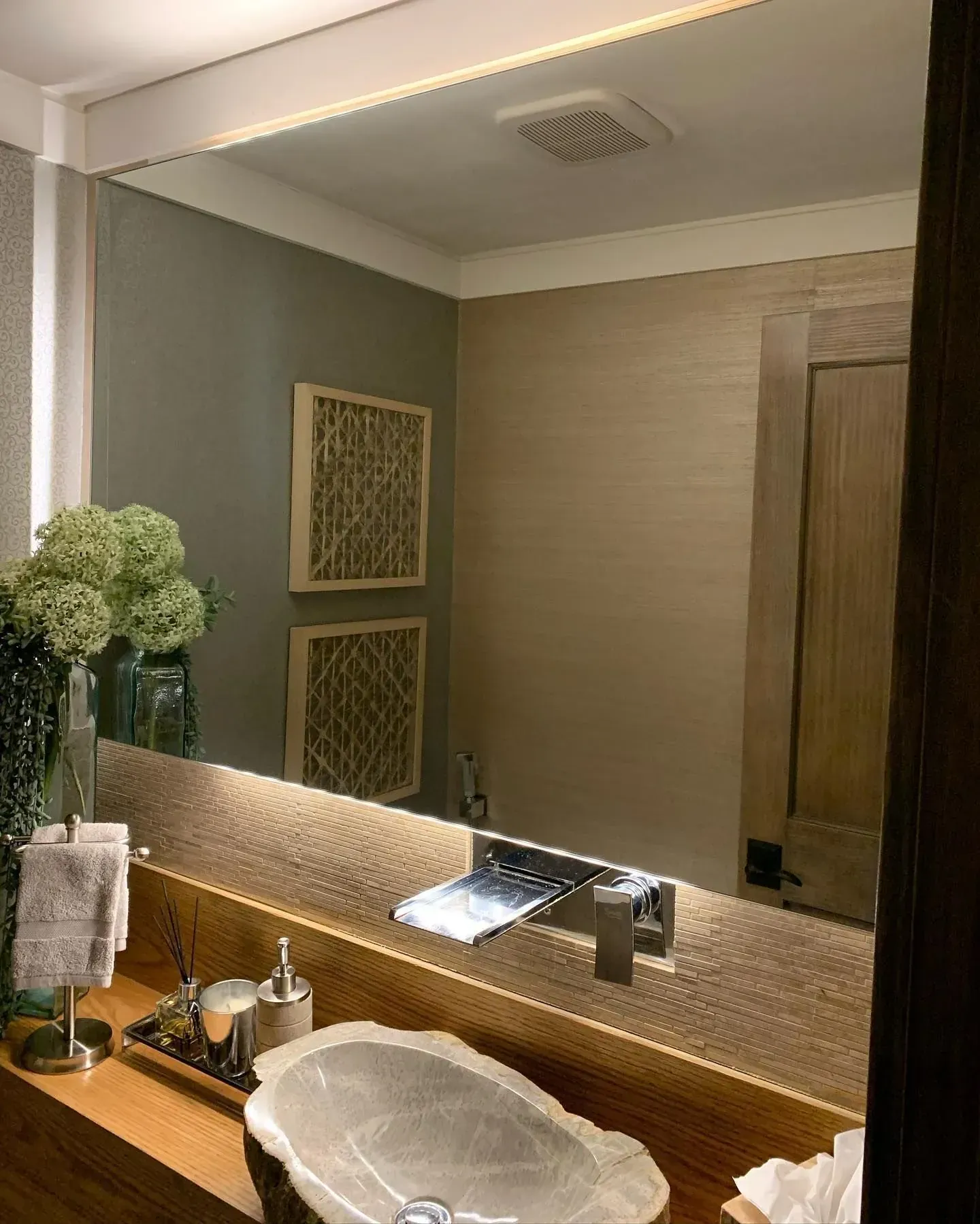 Wall mirror installed above a bathroom vanity