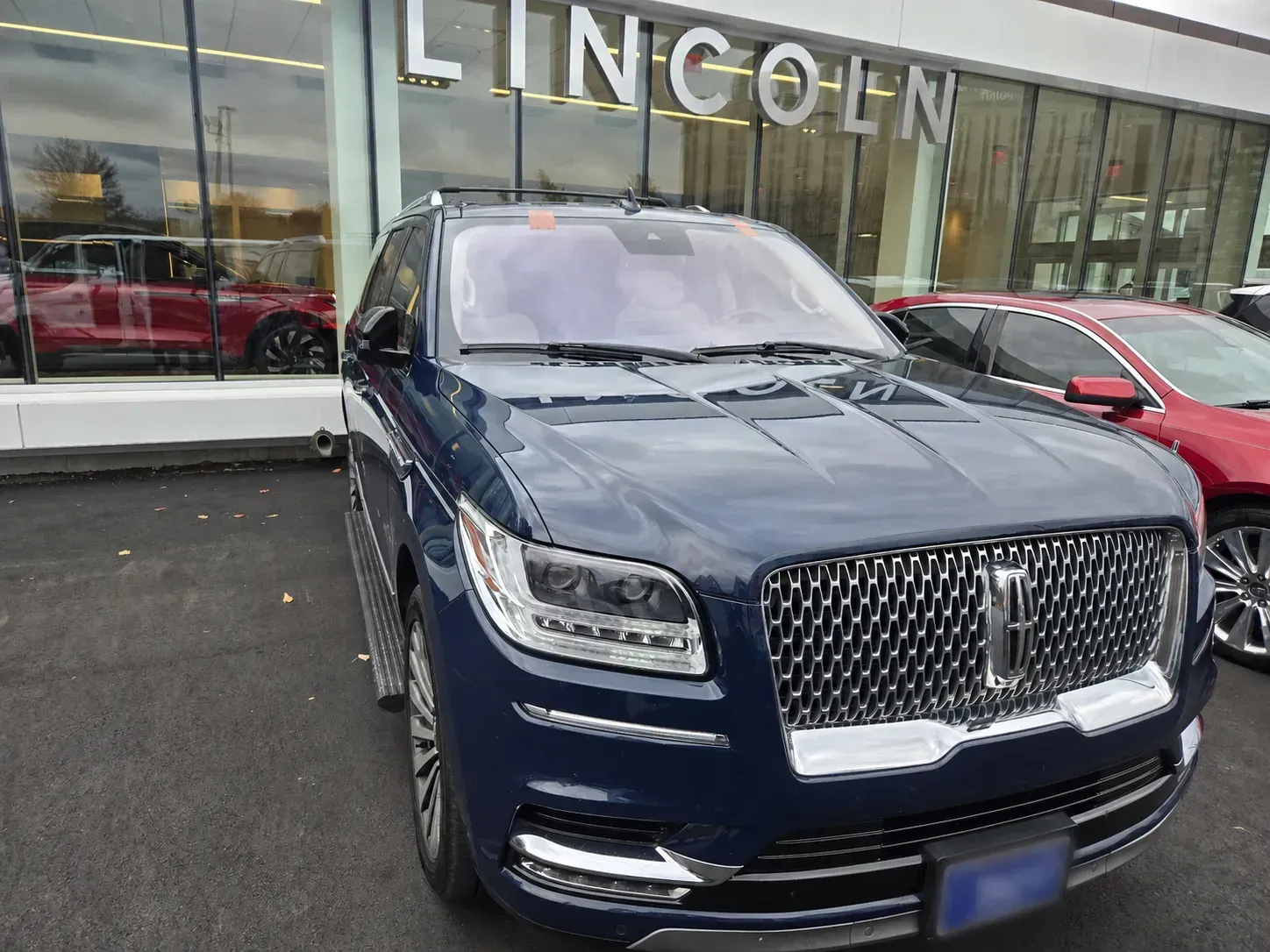 Completed Lincoln windshield installation viewed from the front of the vehicle