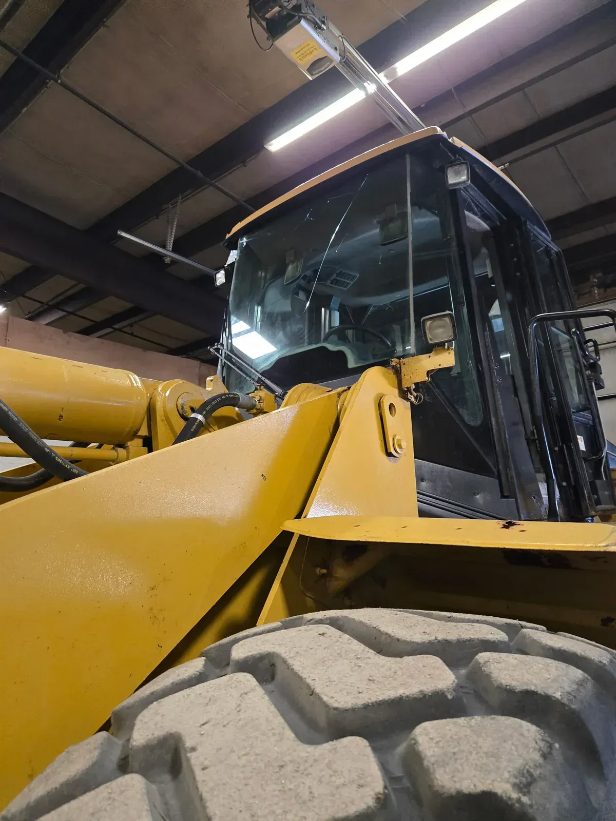 Cracked heavy-equipment windshield before replacement