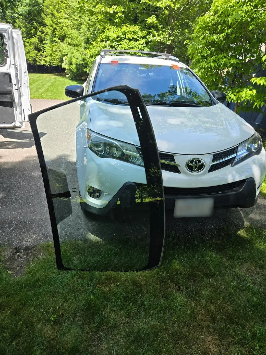 Replacement windshield positioned and ready for a Toyota installation