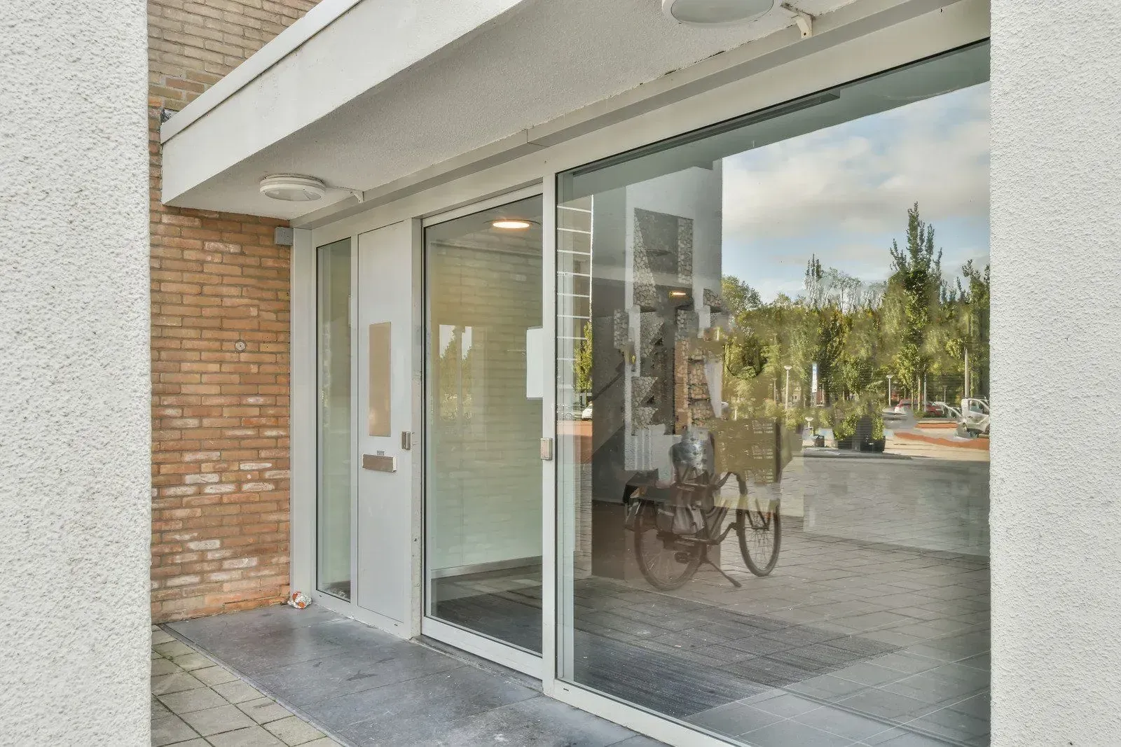 Commercial glass entrance door and surrounding storefront windows