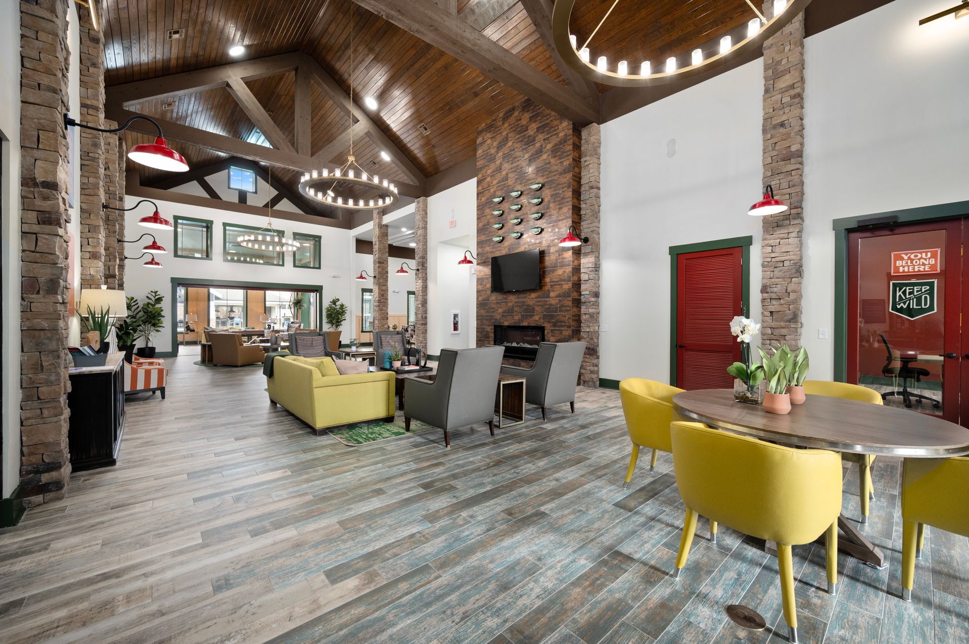 Silver Collection at Cosner's Corner resident lounge with modern cafe-style seating, exposed brick, high ceilings, and community space in Fredericksburg, VA.