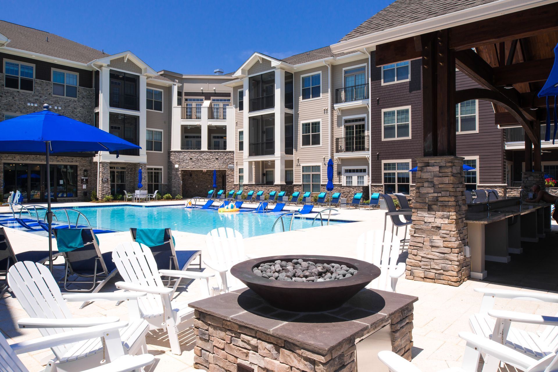 A large building with a swimming pool in front of it
