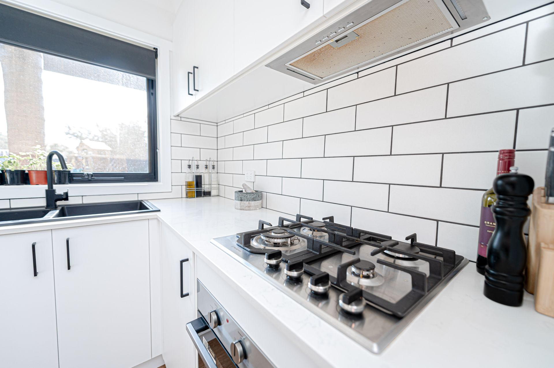 A Bright, Modern Kitchen Featuring White Cabinets, a Gas Cooktop — 2easy Cleaning in Bendigo, VIC