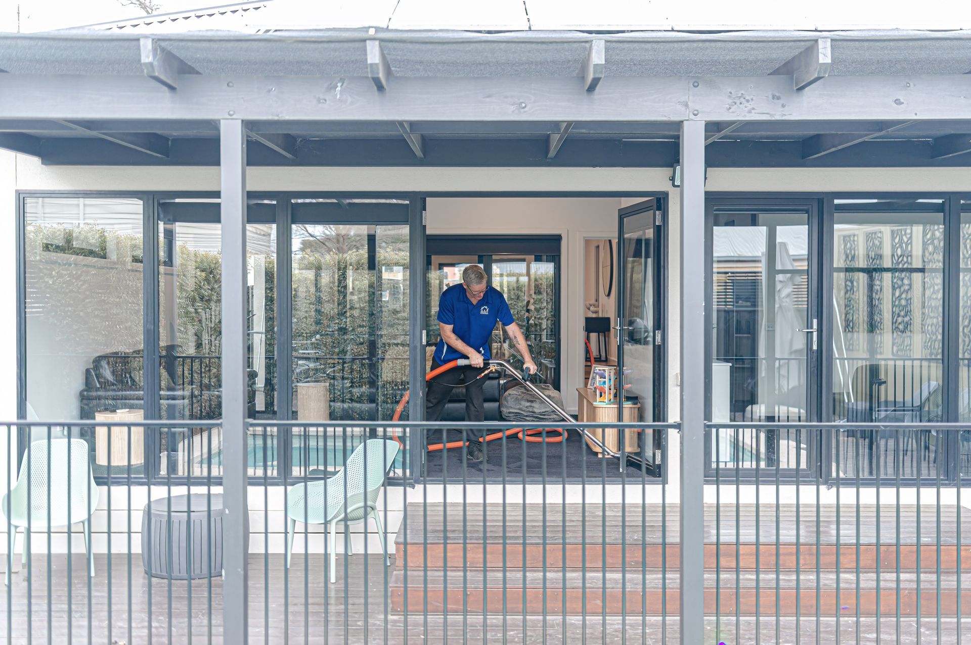 A Man Is Cleaning The Floor of a house with a vacuum cleaner — 2easy Cleaning in Bendigo, VIC