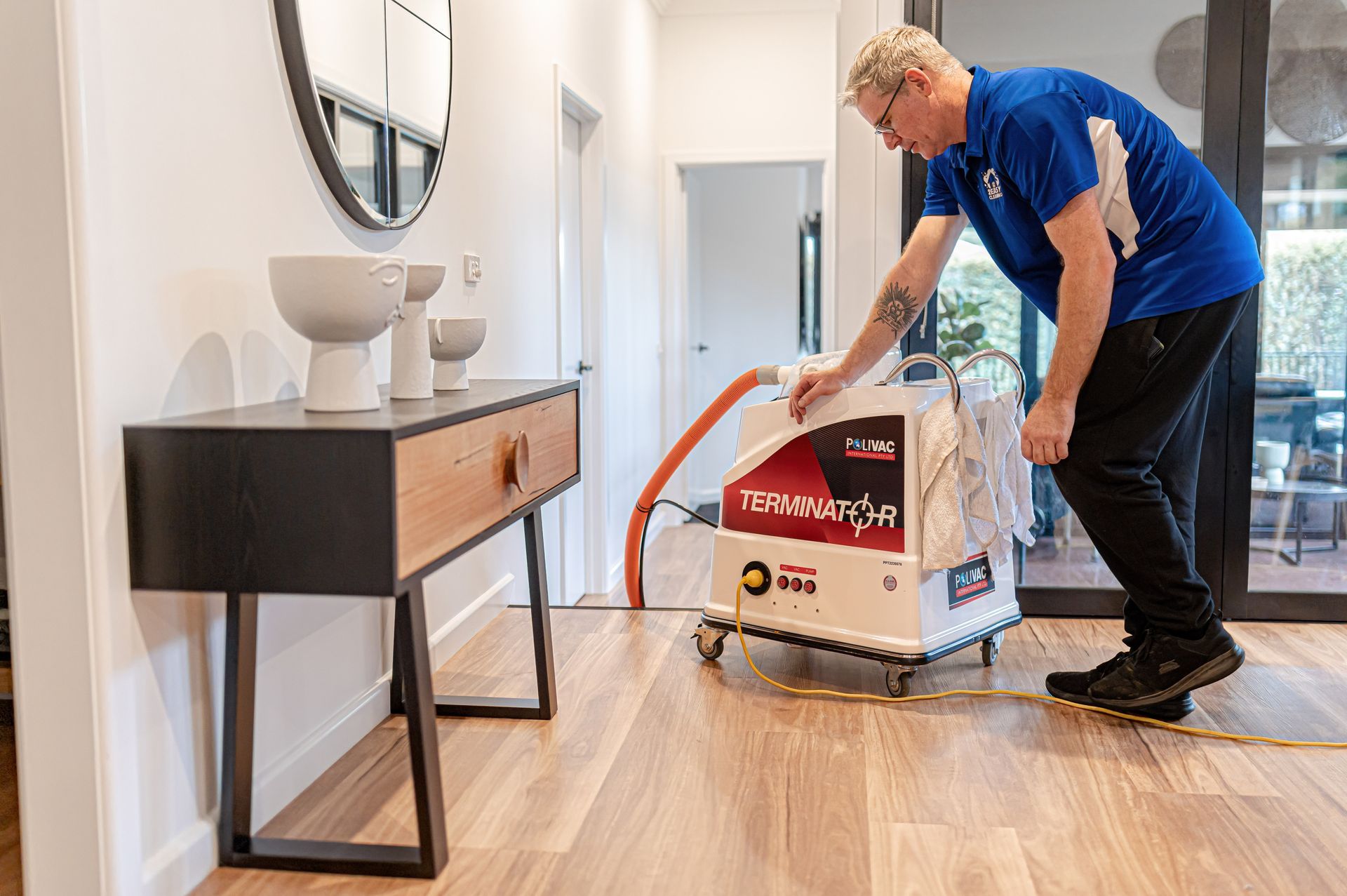 A Technician in a Blue Uniform Operates a Carpet Cleaning Machine — 2easy Cleaning in Bendigo, VIC