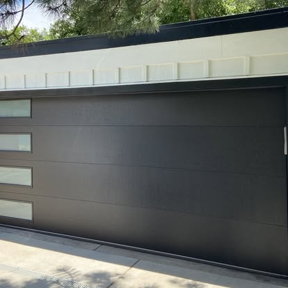 Modern dark gray garage door on a contemporary house exterior