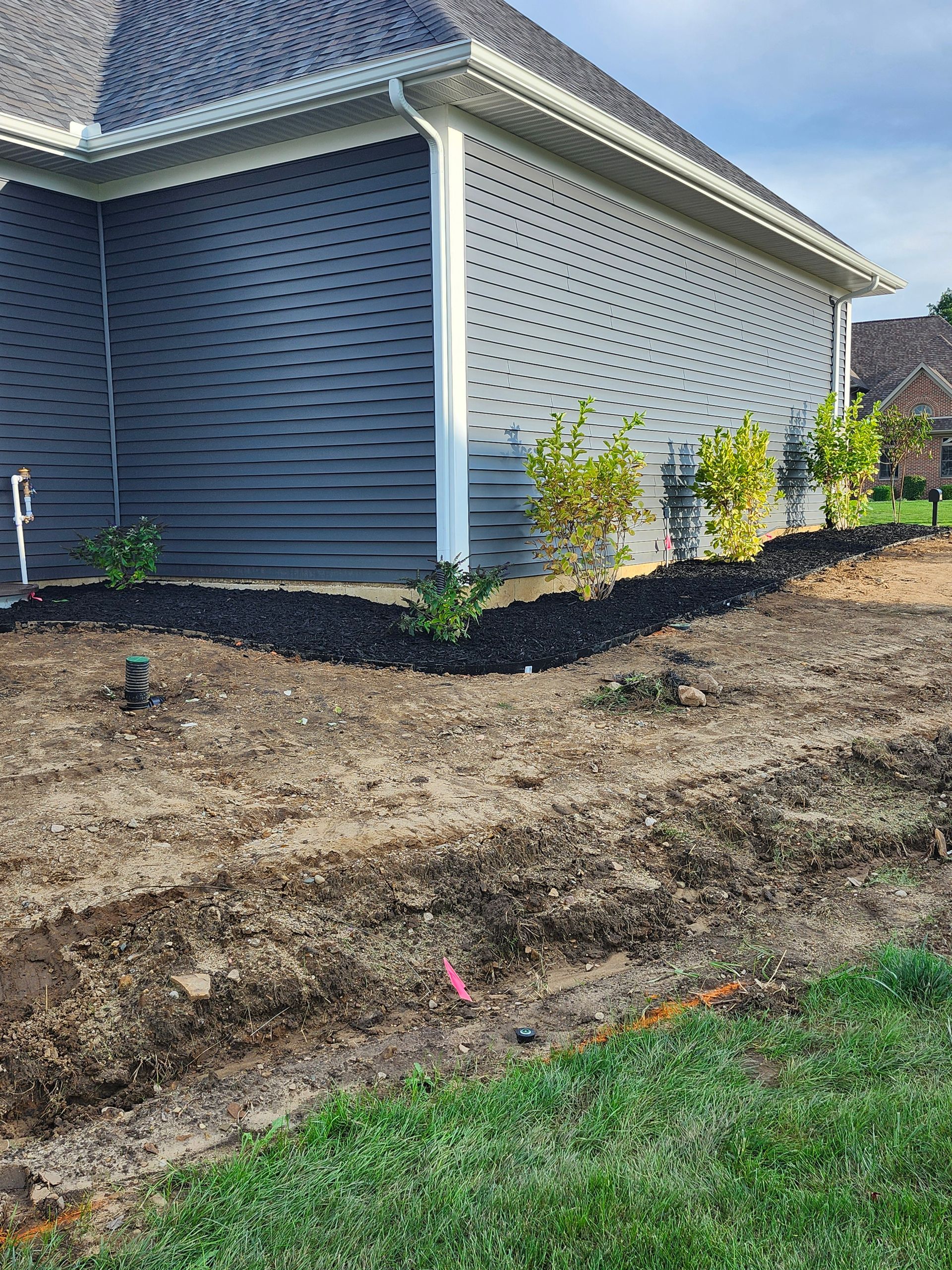 A house with a lot of dirt in front of it.