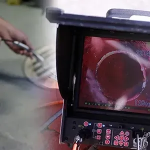 Close-up of a monitor showing an inspection camera view inside a pipe, with control buttons below.