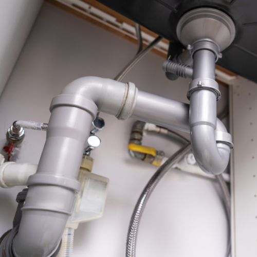 A close up of a plumbing pipe in a kitchen